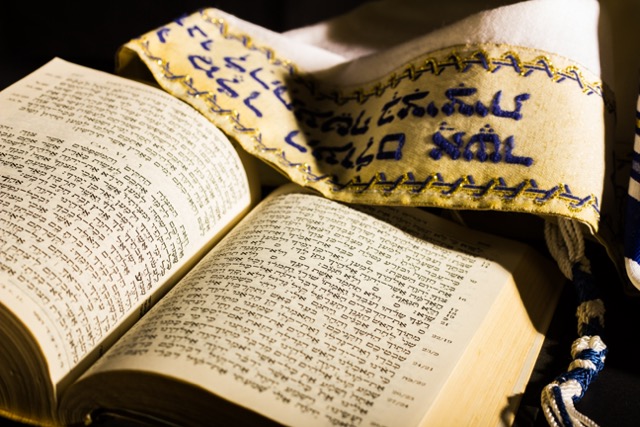 Open machzor prayer book with tallit